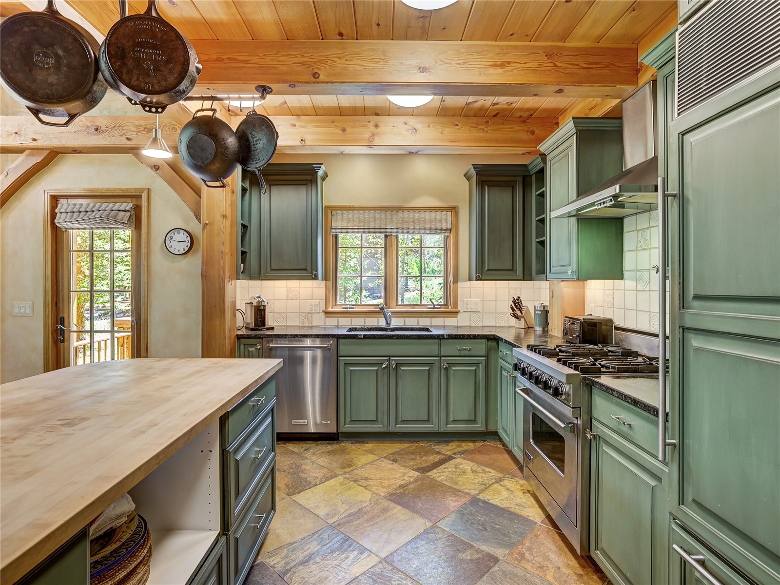840 Penstemon Road Keystone, CO 80435 - Photo 13 of 50 Kitchen featuring green cabinets, appliances with stainless steel finishes, wood counters, plenty of natural light, and a wood ceiling with exposed beams