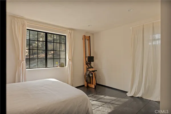 a bedroom with a bed and a mirror