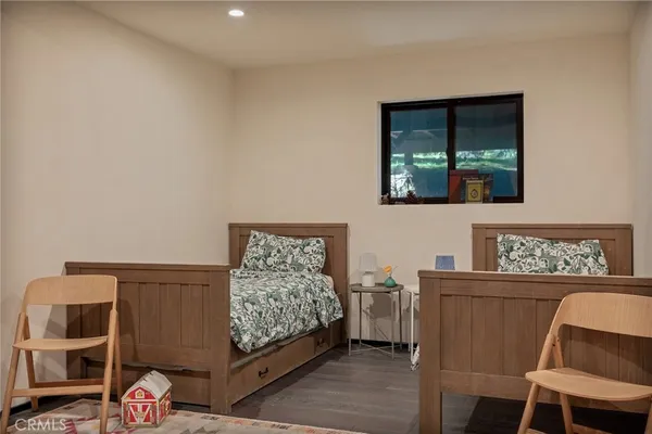 a bedroom with a bed and a painting on the wall