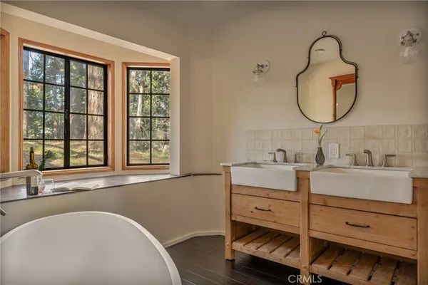 a bathroom with a sink mirror and shower