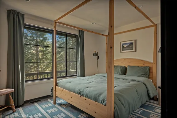 a bedroom with a large bed and a large window