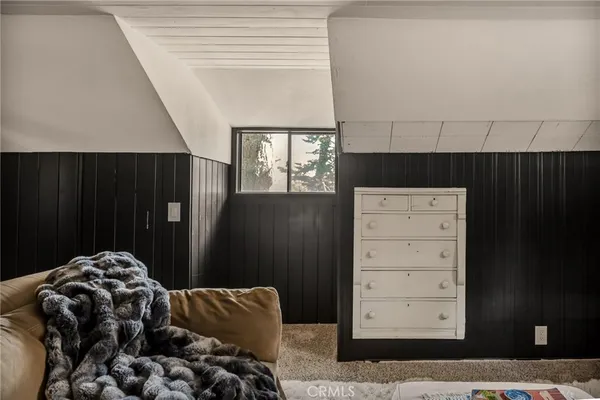 a view of a room with a window and wooden floor
