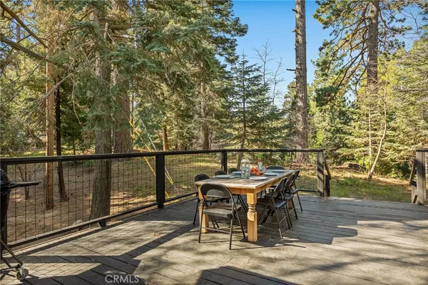 a view of a balcony with chairs and wooden floor