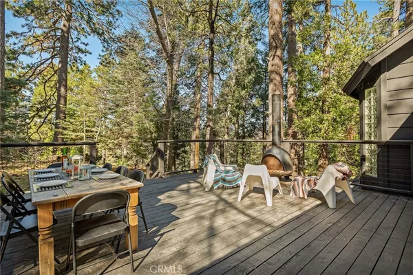 a view of a balcony with wooden floor and outdoor seating