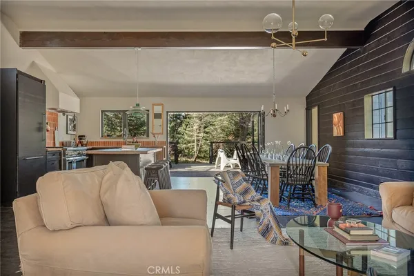 a living room with furniture and a floor to ceiling window