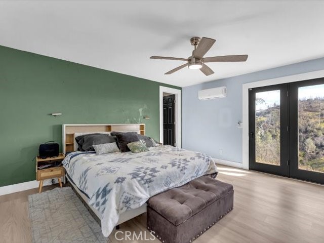 14091 Highview Trail Redding, CA 96003 - Photo 15 of 61 a bedroom with a large bed and a large window