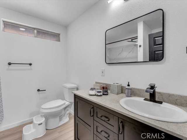 14091 Highview Trail Redding, CA 96003 - Photo 25 of 61 a bathroom with a granite countertop sink mirror vanity and toilet