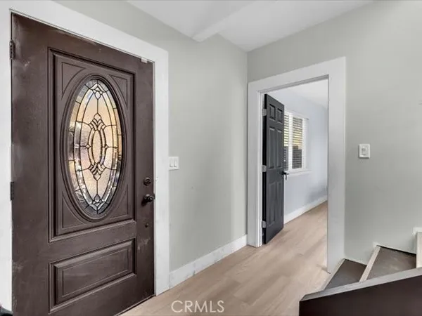 a living room with furniture kitchen view and a chandelier
