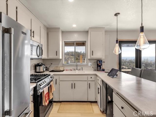 14091 Highview Trail Redding, CA 96003 - Photo 9 of 61 a kitchen with a sink stove and cabinets