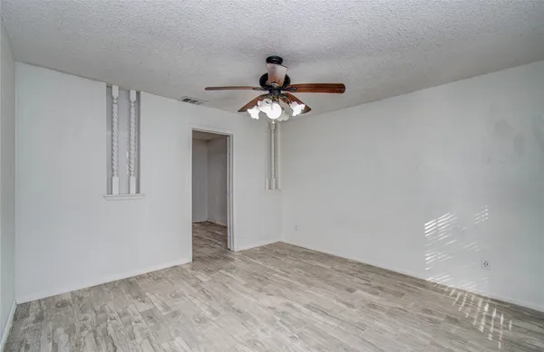 a very nice looking room with a chandelier fan