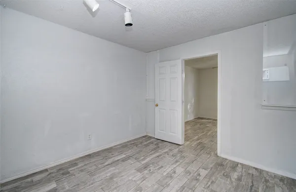a view of a room with wooden floor