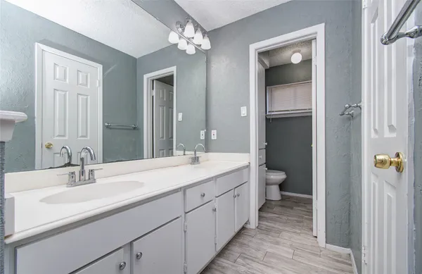 a bathroom with a double vanity sink and a mirror