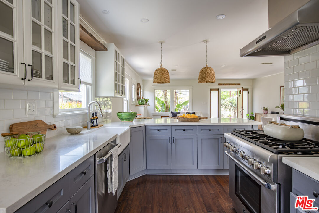 2124 Ridgeview Avenue Los Angeles, CA 90041 - Photo 12 of 33 a kitchen with stainless steel appliances granite countertop a sink a stove and a wooden floors