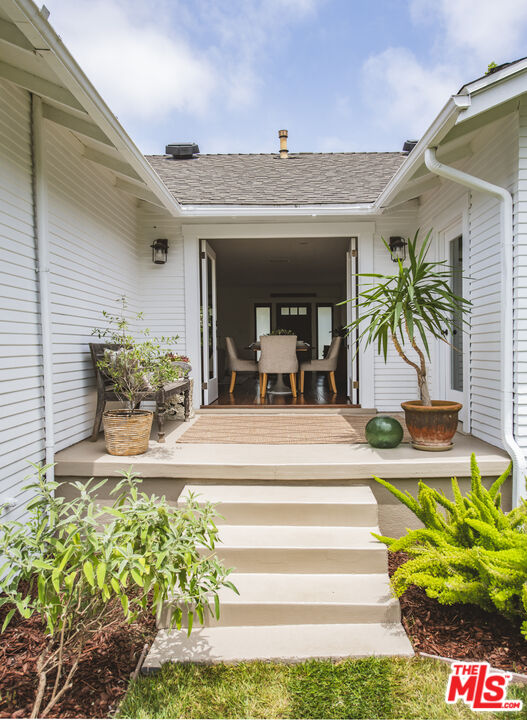 2124 Ridgeview Avenue Los Angeles, CA 90041 - Photo 21 of 33 a view of a patio with table and chairs potted plants