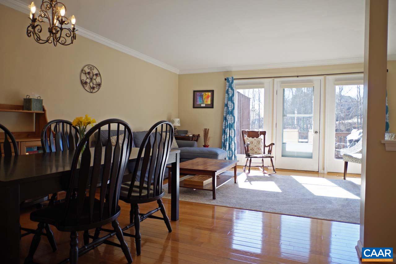 1303 Wimbledon Way Charlottesville, VA 22901 - Photo 11 of 47 a view of a dining room with furniture a chandelier and wooden floor