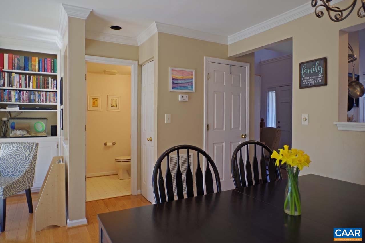 1303 Wimbledon Way Charlottesville, VA 22901 - Photo 21 of 47 a view of a dining room with furniture and a book shelf