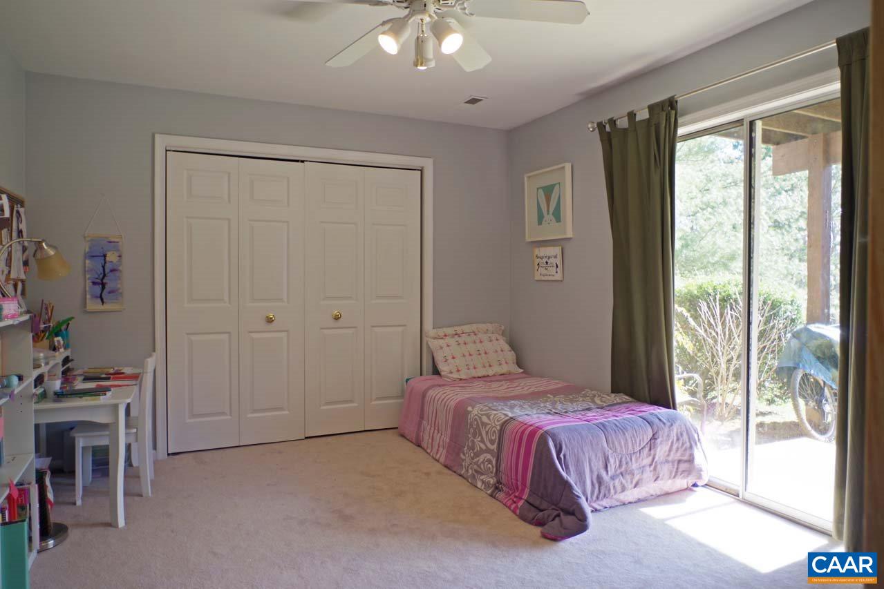 1303 Wimbledon Way Charlottesville, VA 22901 - Photo 45 of 47 a bedroom with a bed and a chandelier