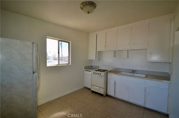 a kitchen with stainless steel appliances granite countertop a sink a stove and a granite counter tops