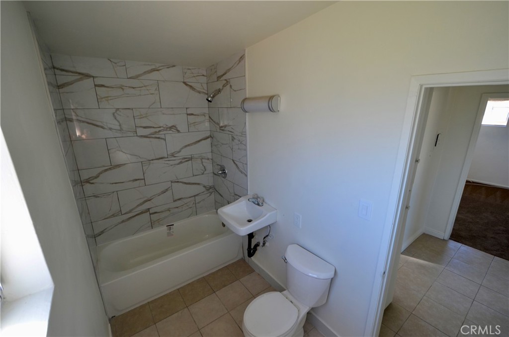 5147 Canoga Street Montclair, CA 91763 - Photo 4 of 10 a bathroom with a toilet and a bathtub