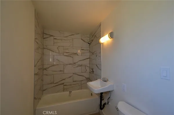 a bathroom with a bathtub and shower