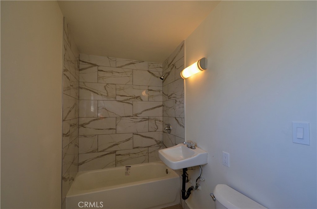 5147 Canoga Street Montclair, CA 91763 - Photo 5 of 10 a bathroom with a bathtub and shower