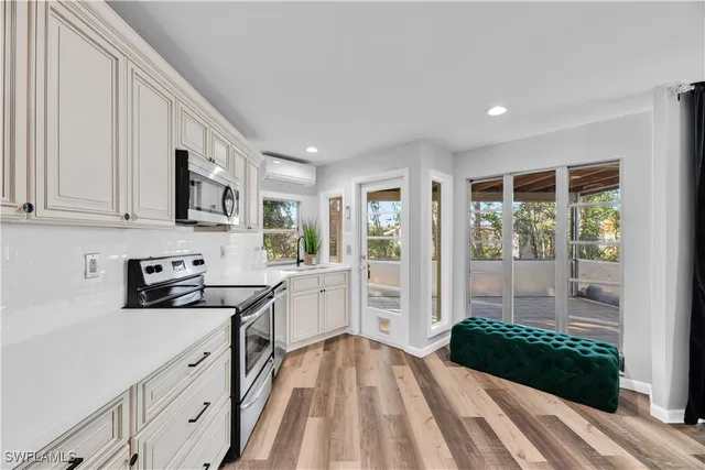 a kitchen with stainless steel appliances granite countertop a stove a sink and a refrigerator
