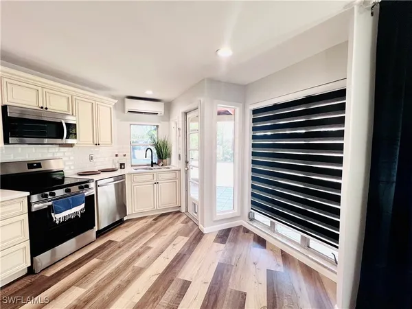 a kitchen with stove cabinets and refrigerator