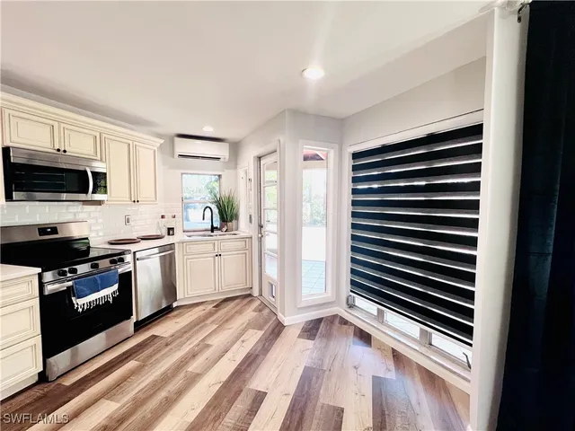 a kitchen with stove cabinets and refrigerator