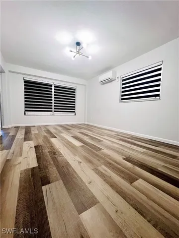 a view of wooden floor and windows in a room