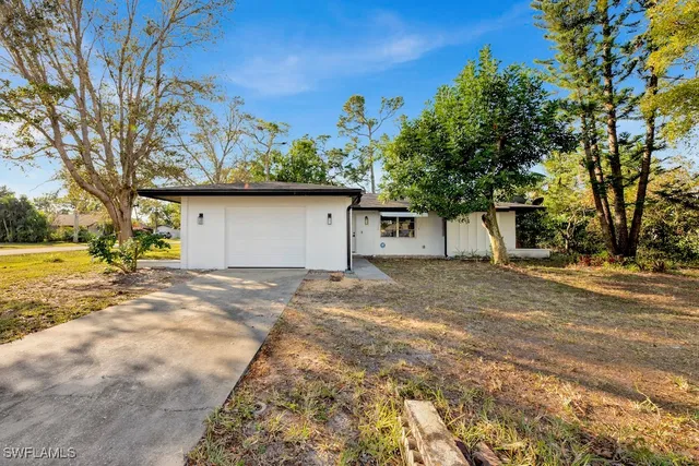 a view of a house with a yard and garage