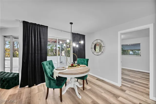 a view of a dining room with furniture and a window