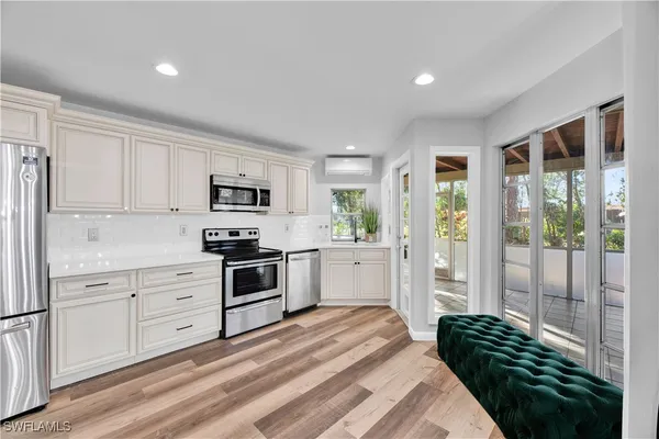 a kitchen with a refrigerator and windows