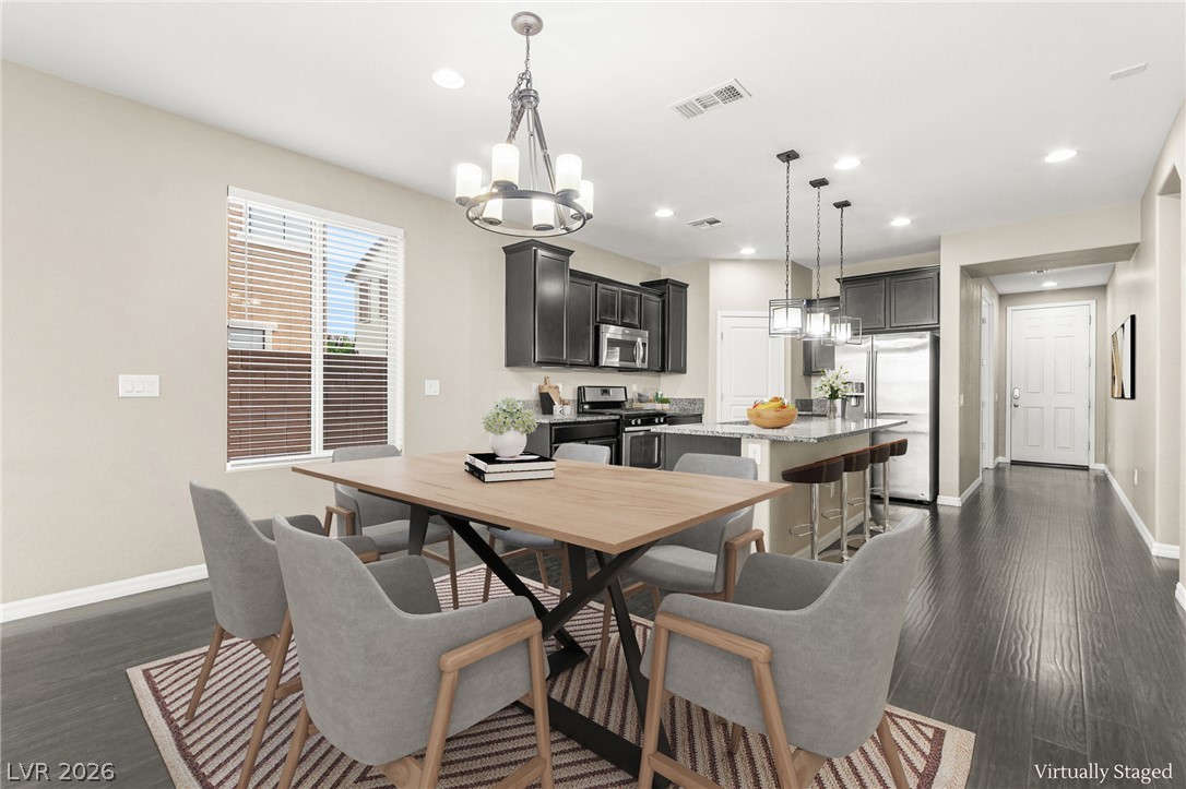 11048 Prairie Grove Road Las Vegas, NV 89179 - Photo 18 of 75 An open concept design seamlessly connects the dining area to a well-appointed kitchen, ideal for entertaining.