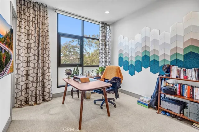 a spacious bedroom with a bed and a dresser in it