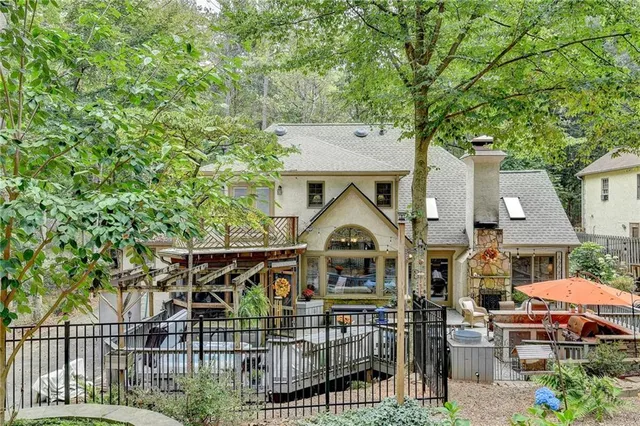 a bathroom with a granite countertop sink a mirror and shower