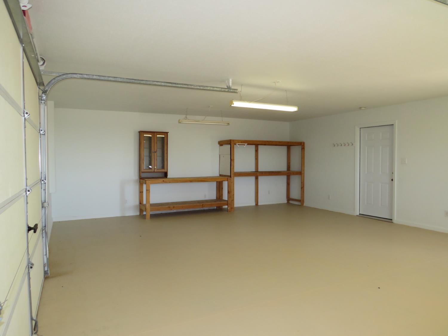 31180 Knob Cone Road Gold Run, CA 95717 - Photo 30 of 70 Oversized 1-car garage with workshop, under stair storage area, window and exterior door.