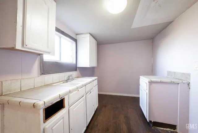a utility room with cabinets washer and dryer