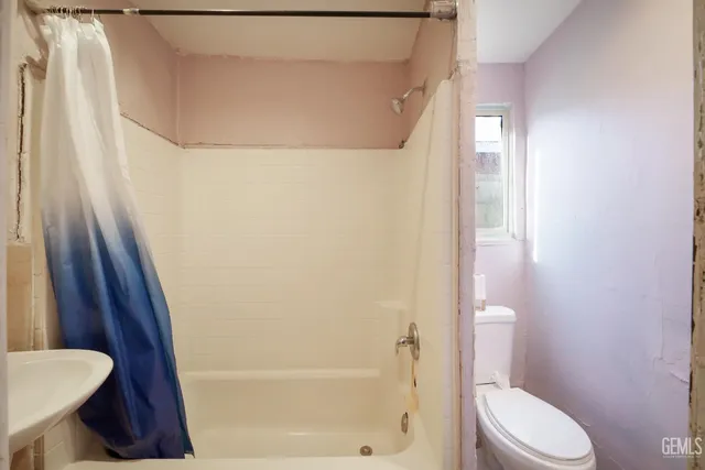 a white toilet sitting next to a bathroom sink