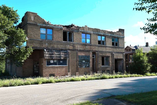 a front view of a house with a yard and a garage