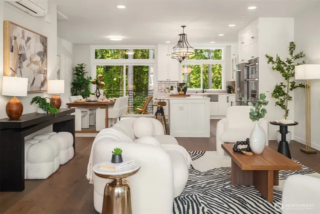 a living room with furniture a large window and white walls