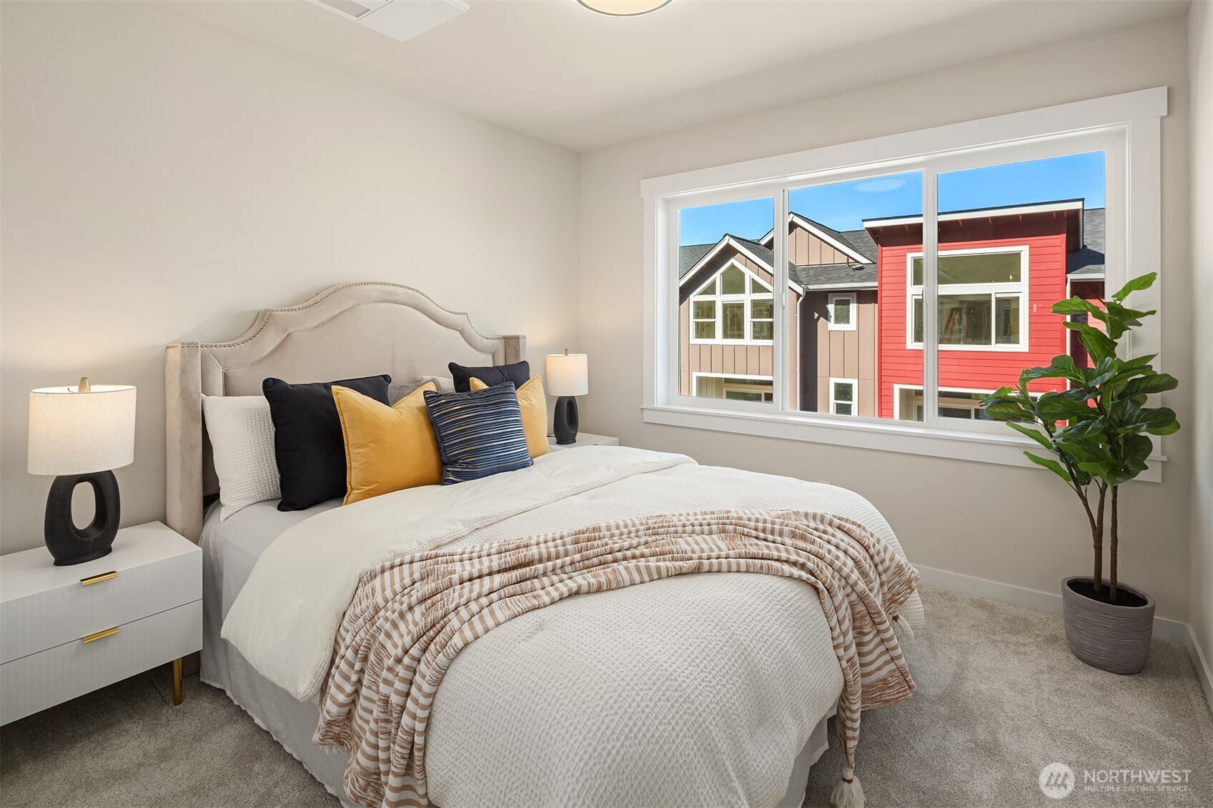 19722 Filbert Drive, Unit 3 Bothell, WA 98012 - Photo 30 of 36 a bedroom with bed and a potted plant