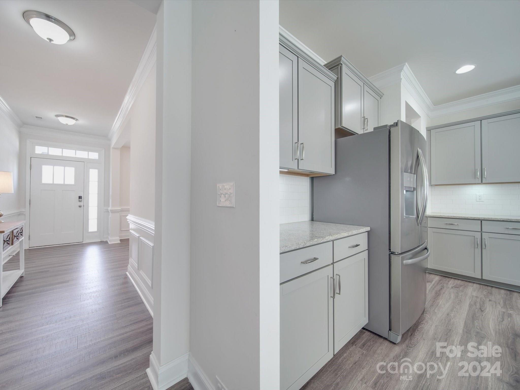 5901 Redwood Pine Road Concord, NC 28027 - Photo 13 of 39 a kitchen with white cabinets and wooden floors