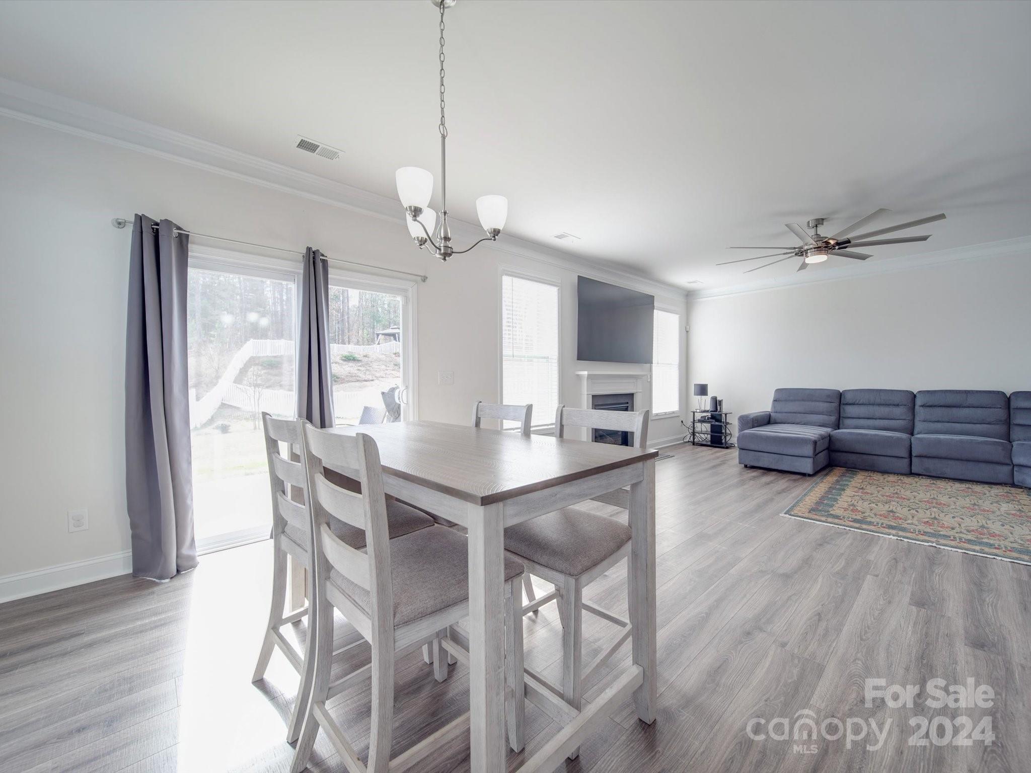 5901 Redwood Pine Road Concord, NC 28027 - Photo 17 of 39 a view of a dining room with furniture window and wooden floor