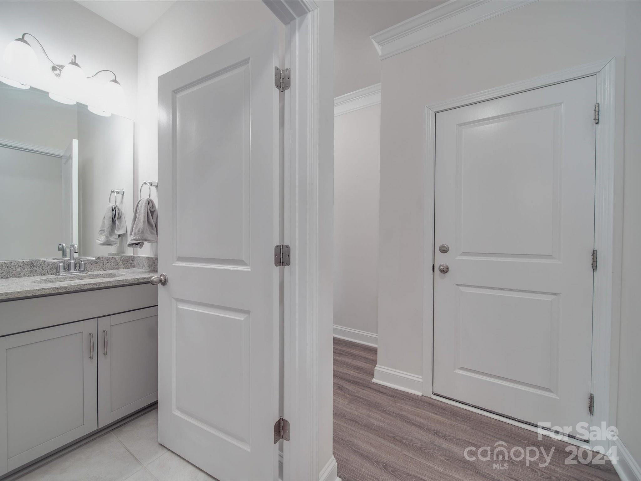 5901 Redwood Pine Road Concord, NC 28027 - Photo 23 of 39 a bathroom with a granite countertop sink and a mirror