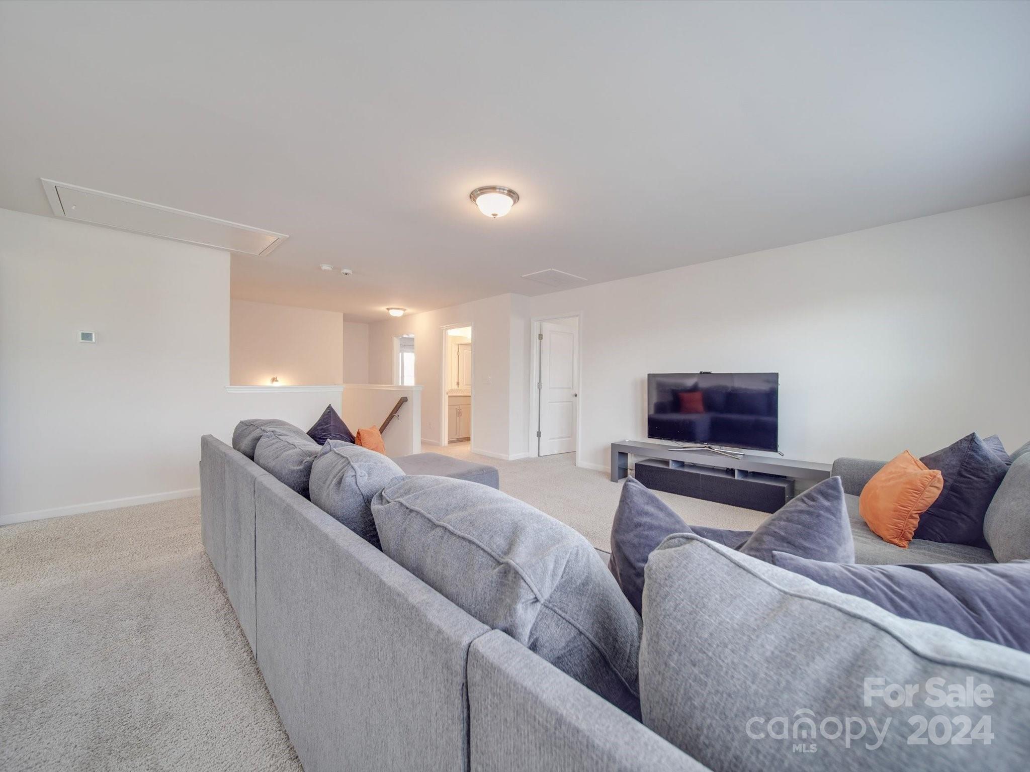5901 Redwood Pine Road Concord, NC 28027 - Photo 25 of 39 a living room with furniture and a flat screen tv