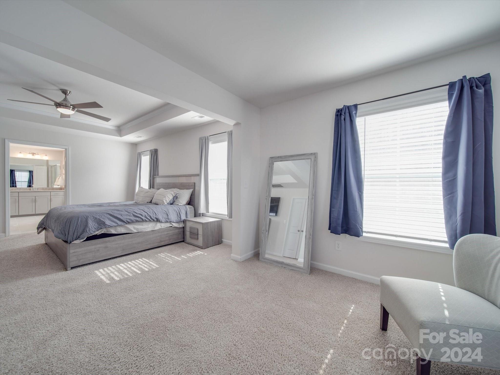 5901 Redwood Pine Road Concord, NC 28027 - Photo 28 of 39 a spacious bedroom with a bed a couch and a window