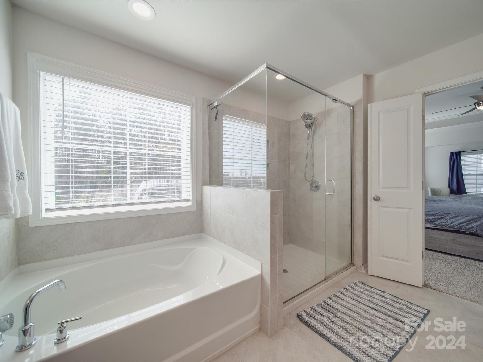 5901 Redwood Pine Road Concord, NC 28027 - Photo 31 of 39 a bathroom with a bathtub and a shower