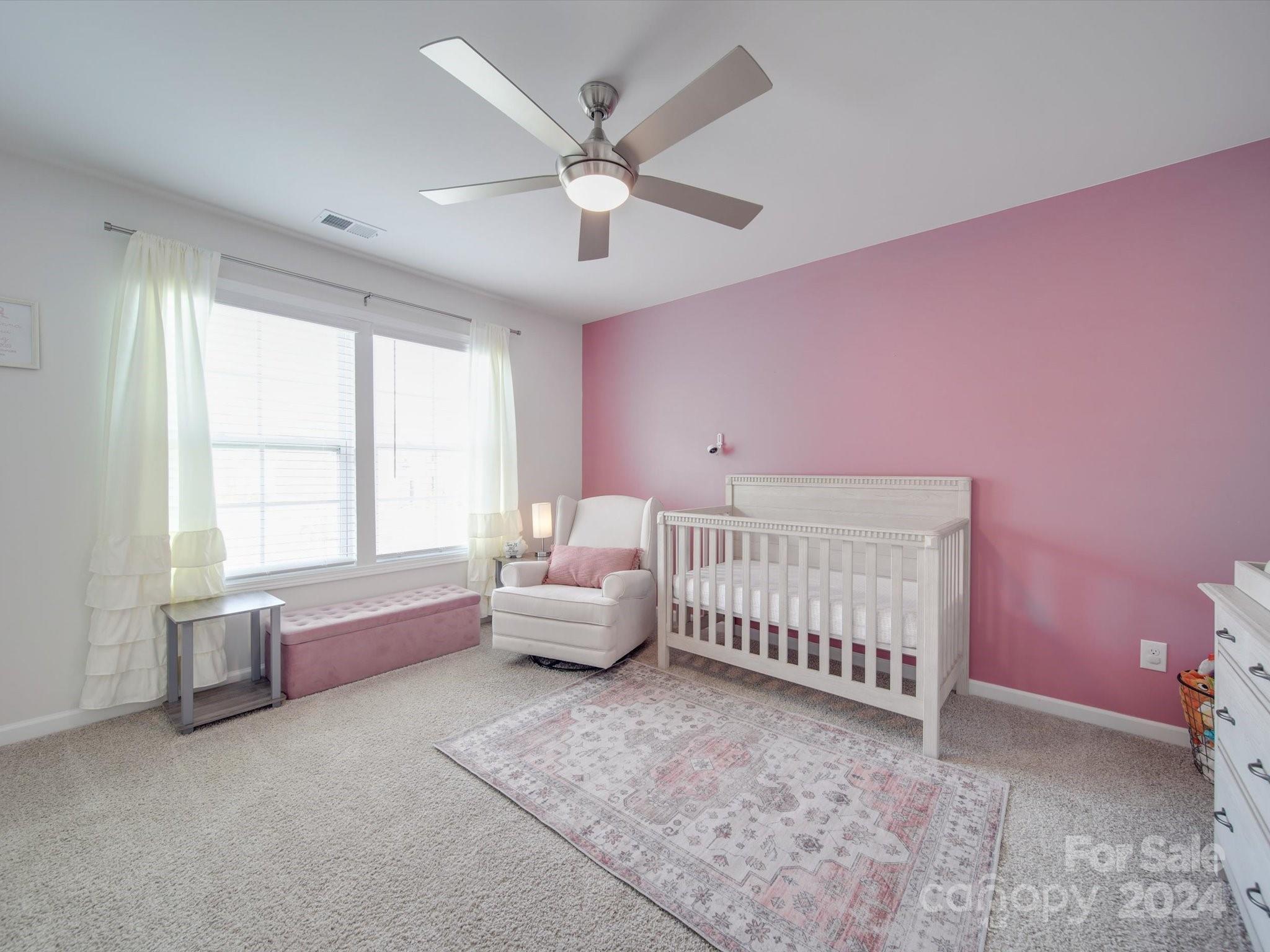 5901 Redwood Pine Road Concord, NC 28027 - Photo 34 of 39 a spacious bedroom with a bed and a chandelier