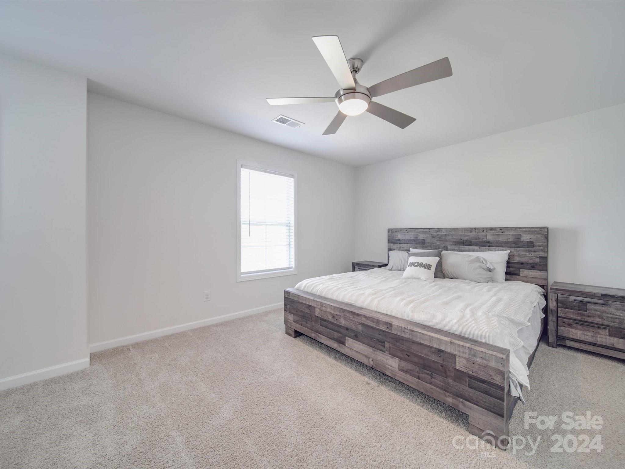 5901 Redwood Pine Road Concord, NC 28027 - Photo 36 of 39 a bedroom with a large bed and window