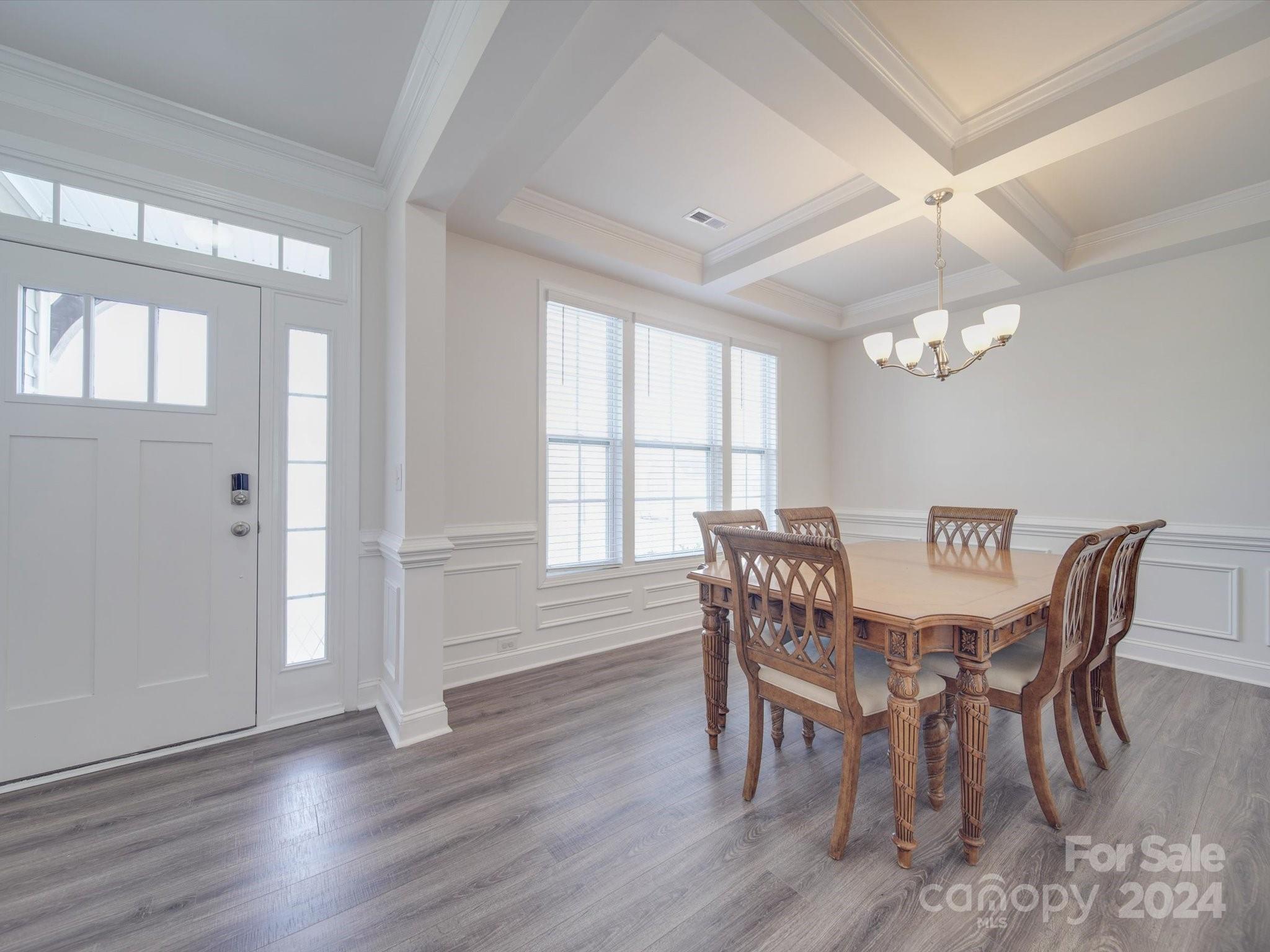 5901 Redwood Pine Road Concord, NC 28027 - Photo 5 of 39 a view of a dining room with furniture a chandelier and wooden floor